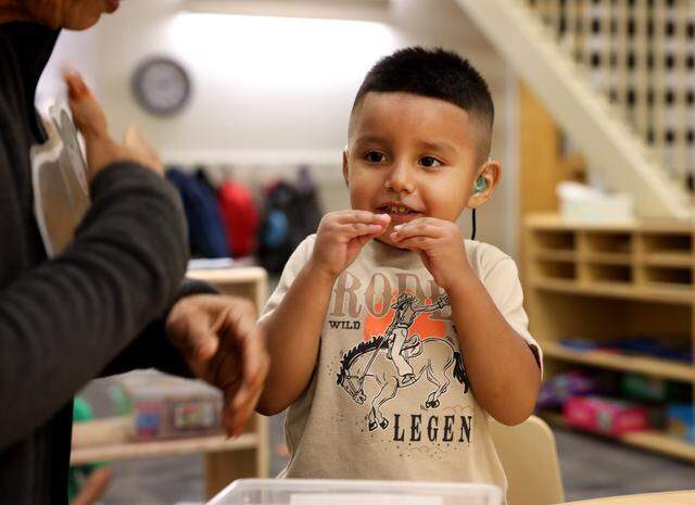 Jacob, 3, uses sign language while communicating with para professional Ruth Rodriguez on Thursday, March 5, 2026, at the Callier Center in Dallas. The Callier Child Development Program serves kids who are deaf and hard of hearing. 